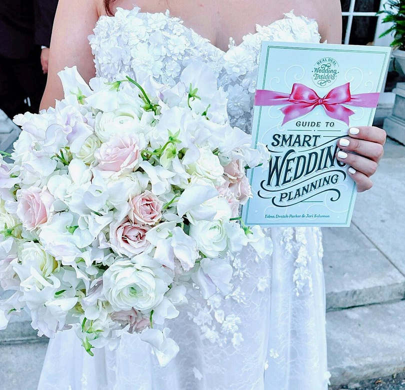 Bride Holding the Guide to Smart Wedding Planning book